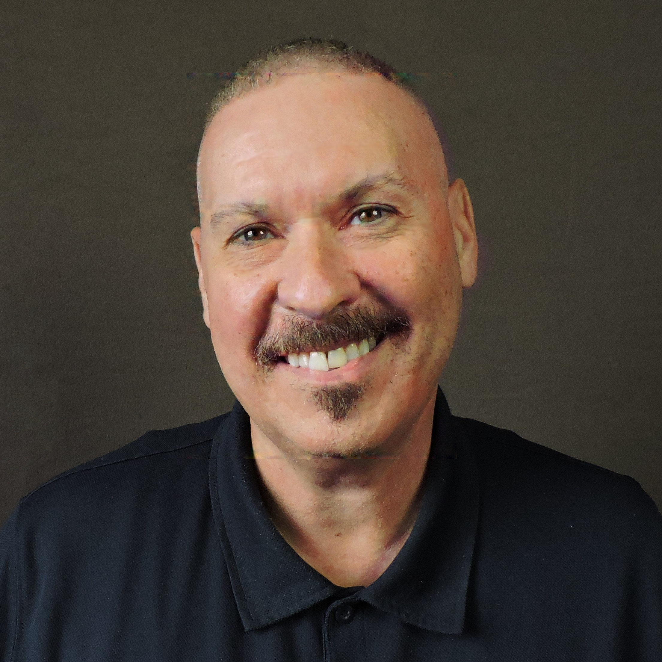 Joe Magdaleno smiling in black polo shirt