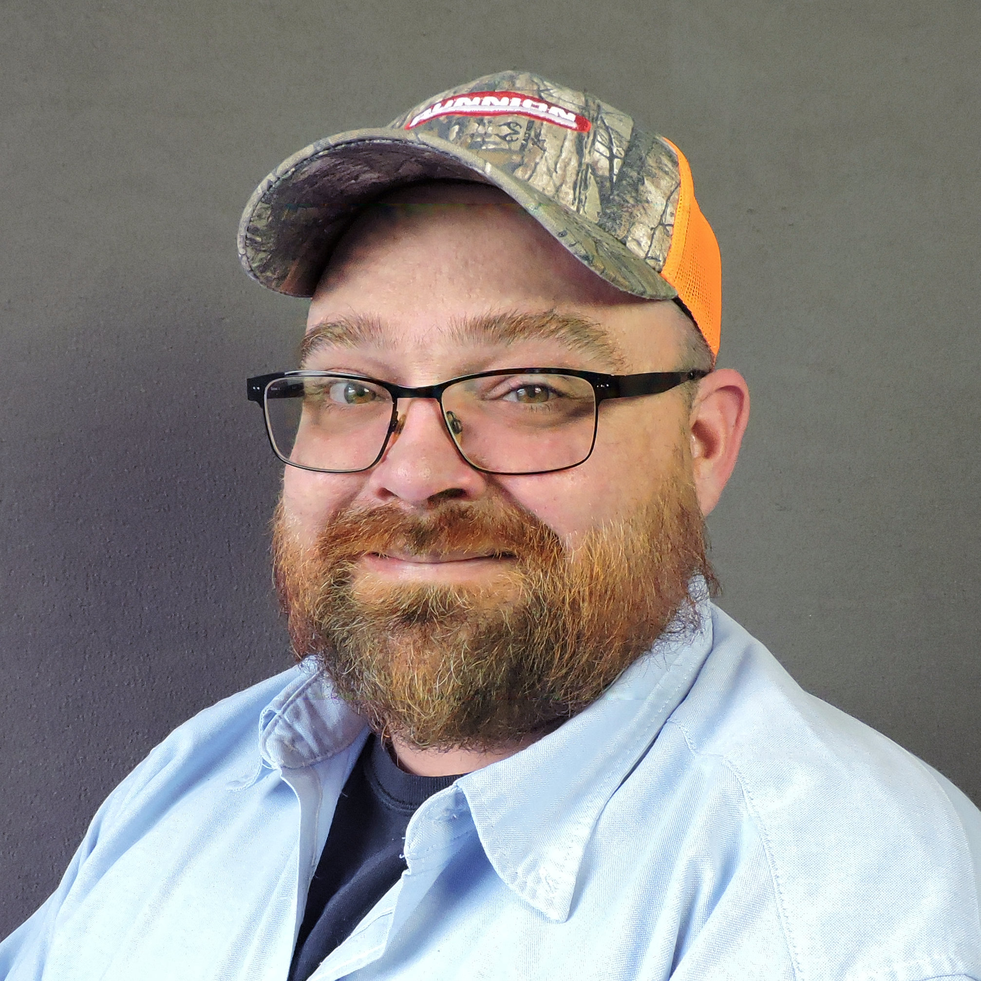 Bobby Drazdik smiling in light blue collar shirt