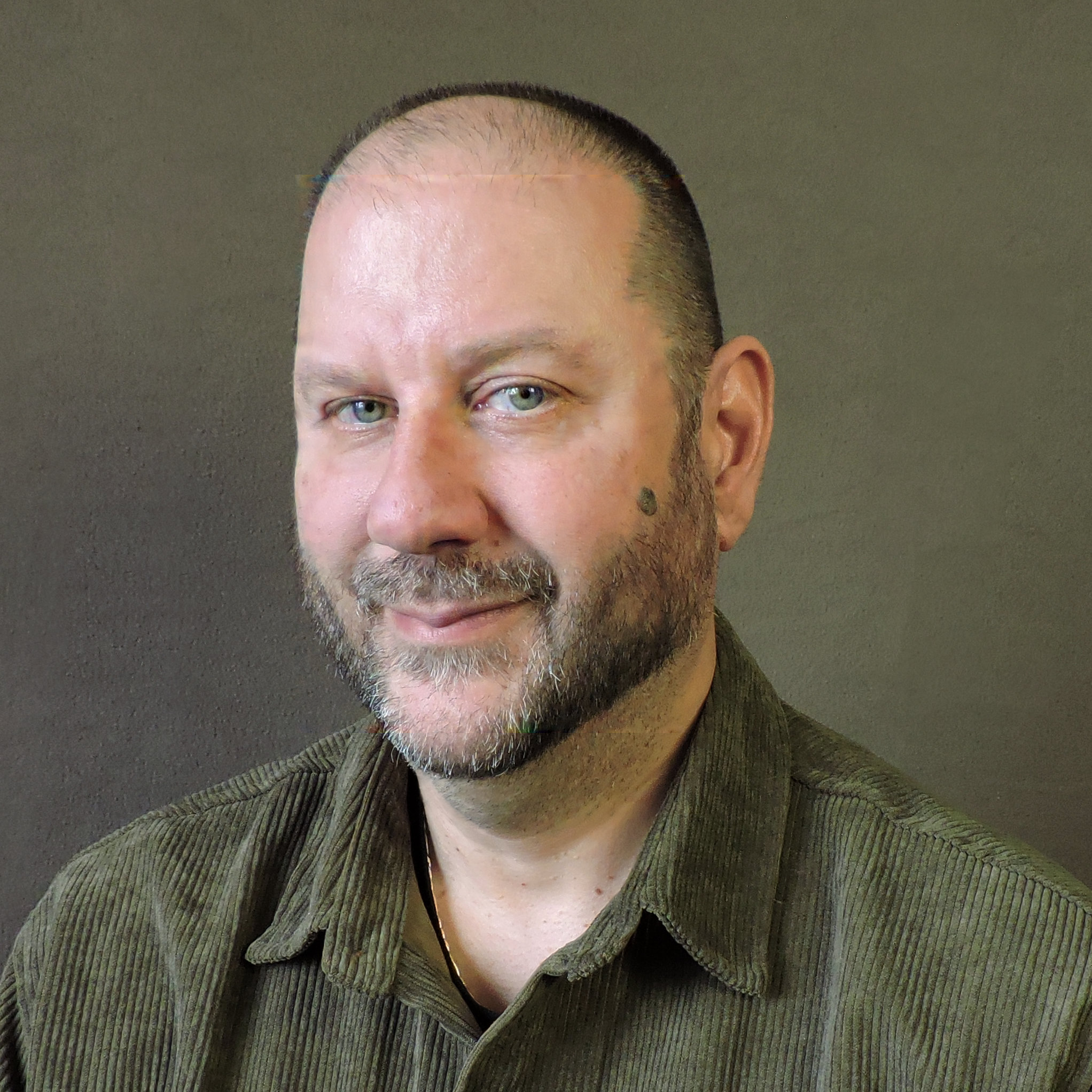 Ken Knobloch smiling in green shirt